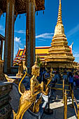 Bangkok Grand Palace, Wat Phra Kaew, an Apsarasingha combination of an apsara (nymph) and a singha (lion), on the bachground one of the gilded chedi of the Royal Pantheon. 